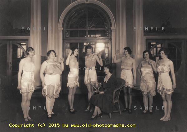 Ladies displaying lingerie and trophy cup